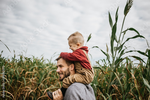 Father and son exploring corn maze in the fall
