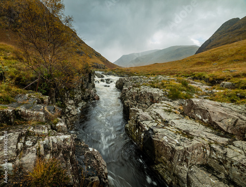 long exposure shot of the waterfalls in glen etive near loch etive and the entrance to glencoe and rannoch moor in the argyll region of the highlands of scotland during autumn