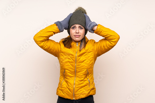 Woman with winter hat over isolated background with surprise facial expression © luismolinero