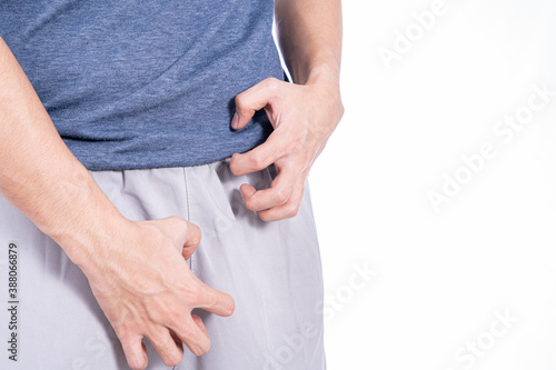 Man hands scratching his crotch isolated white background. Medical, healthcare for advertising concept. photo