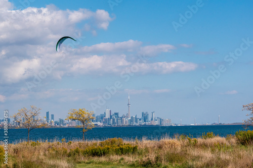 Canvas Print A parasurfer surfs in Lake Ontario in Colonel Samuel Smith Park with the Downtown Toronto, Ontario skyline in the background