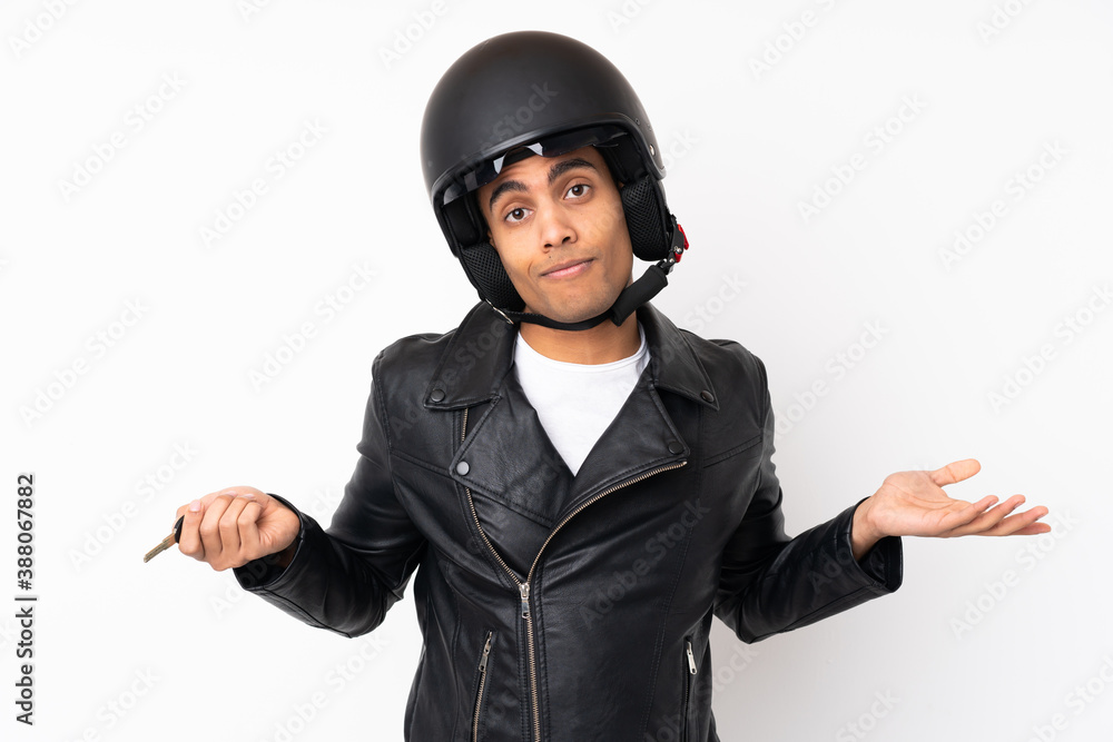 Young handsome man with a motorcycle helmet over isolated white background Young handsome man with a motorcycle helmet over isolated white background