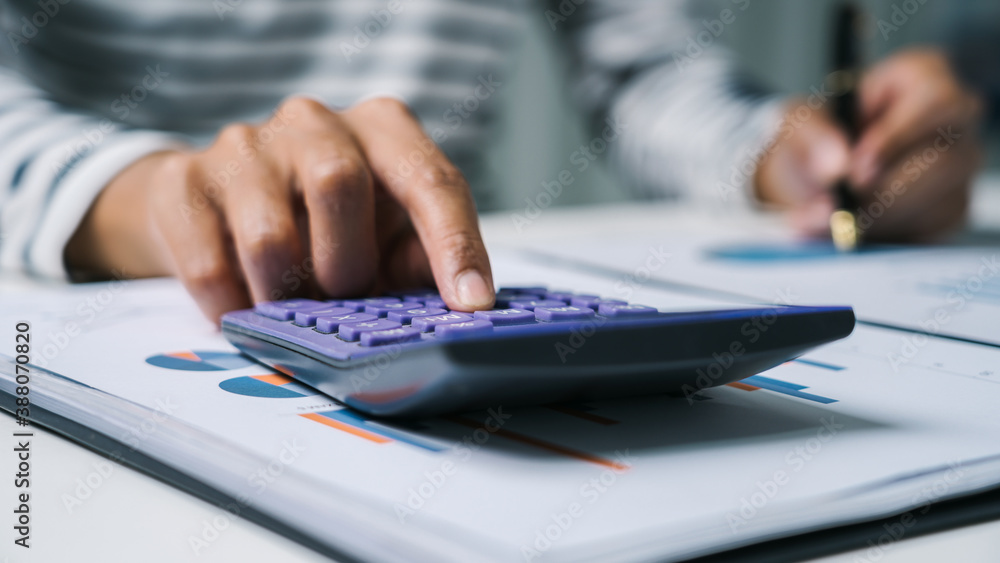 Close up business woman secretary using calculator to do math finance in office with tax accounting statistics research concept. Close up business woman secretary using calculator to do math finance in office with tax accounting statistics research concept.