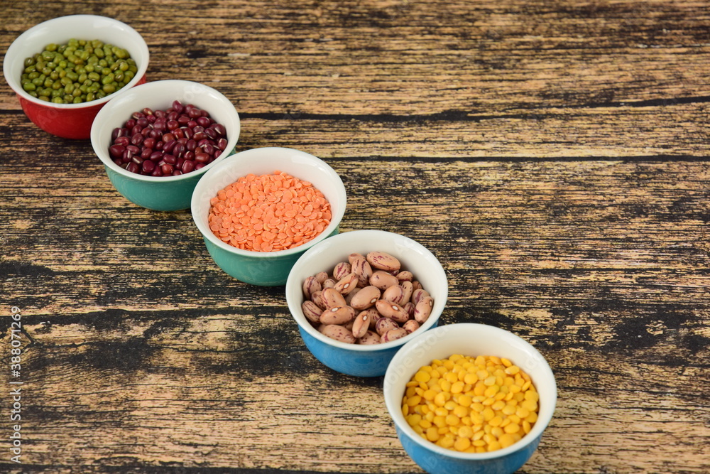 Assorted Legumes: mung beans and red , yellow lentils on wooden background Assorted Legumes: mung beans and red , yellow lentils on wooden background