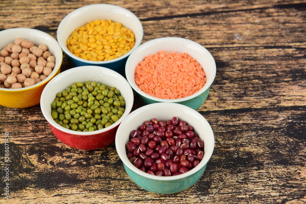 Assorted Legumes: beans and lentils variety on wooden background Assorted Legumes: beans and lentils variety on wooden background