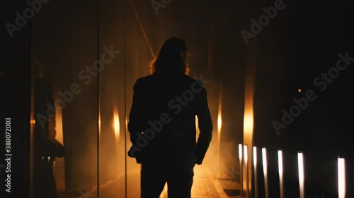 presentable man walks into the spotlights