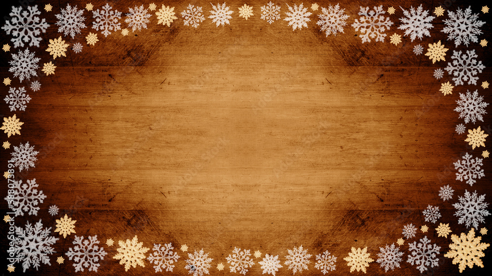 Christmas snow winter background - Frame made of ice crystals on brown wooden wood texture, top view with space for text Christmas snow winter background - Frame made of ice crystals on brown wooden wood texture, top view with space for text