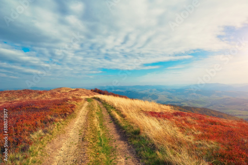 Trail in the autumn mountains. Calm landscape with beautiful clouds. Carpathians.