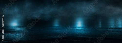 Dark abstract background. Empty dark street background at night. Spotlight reflects on the asphalt, blurry night lights. Smoke, fog. 