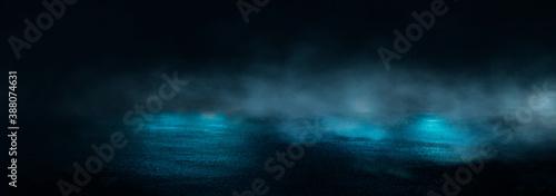 Dark abstract background. Empty dark street background at night. Spotlight reflects on the asphalt, blurry night lights. Smoke, fog. 