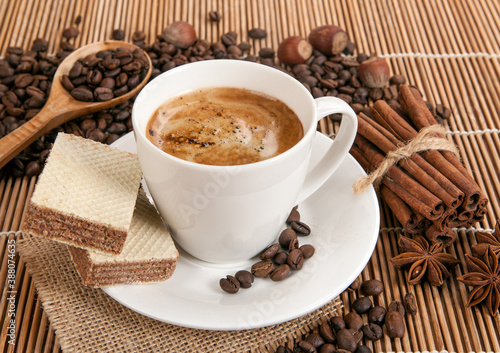 cup of coffee with froth on a bamboo napkin still life