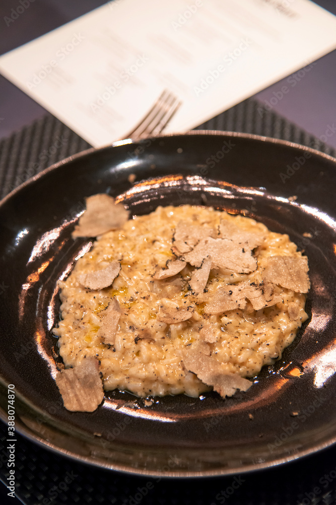 Close up of risotto sprinkle with sliced black truffle Close up of risotto sprinkle with sliced black truffle