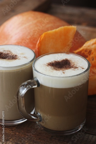 Pumpkin latte on a wooden table macro 