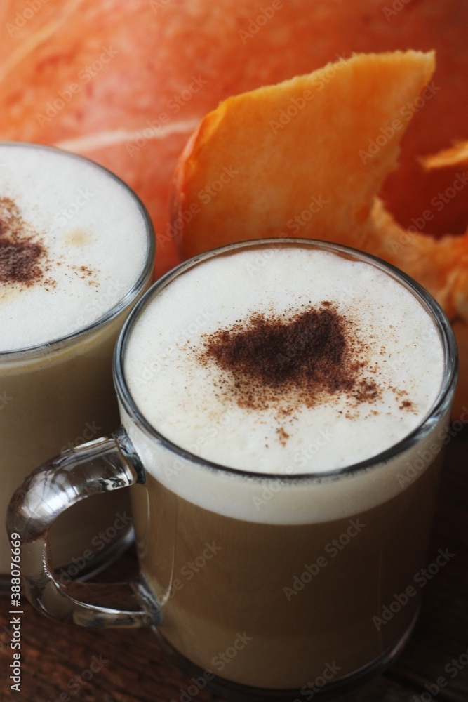 Pumpkin latte on a wooden table macro Pumpkin latte on a wooden table macro