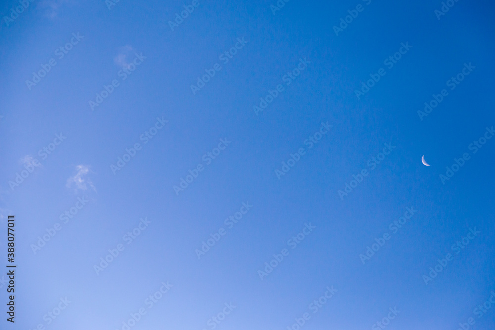 A young month in the blue sky in the early evening. A young month in the blue sky in the early evening.
