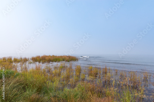 Eastern shore of Lake Baikal on a foggy day. Stones and grass