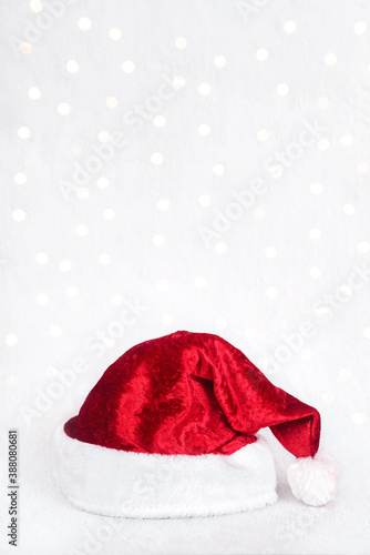 Merry Christmas.Red santa hat isolated over Christmas lights