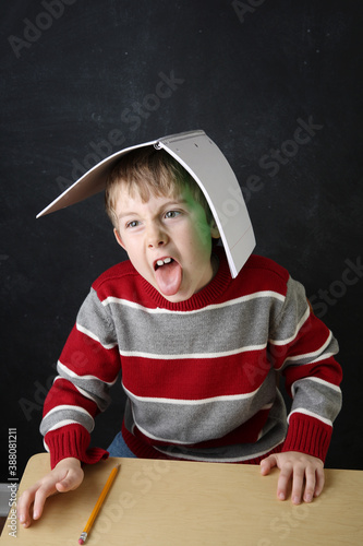 Bild auf Leinwand Student acting up and misbehaving during learning time with his notebook on his