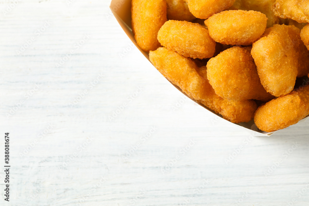 Tasty fried chicken nuggets on white wooden table, top view. Space for text Tasty fried chicken nuggets on white wooden table, top view. Space for text