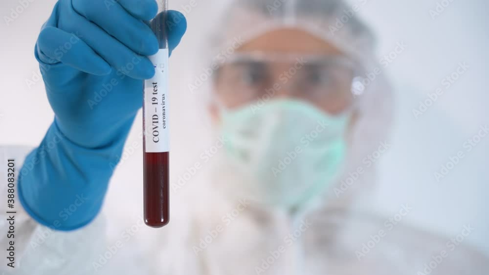 One scientist male wear protective suit, blue gloves, mask shows, holds in hand medical drug Sputnik V – sample of Covid-19 coronavirus vaccine in glass test tube isolated on white background close up One scientist male wear protective suit, blue gloves, mask shows, holds in hand medical drug Sputnik V – sample of Covid-19 coronavirus vaccine in glass test tube isolated on white background close up