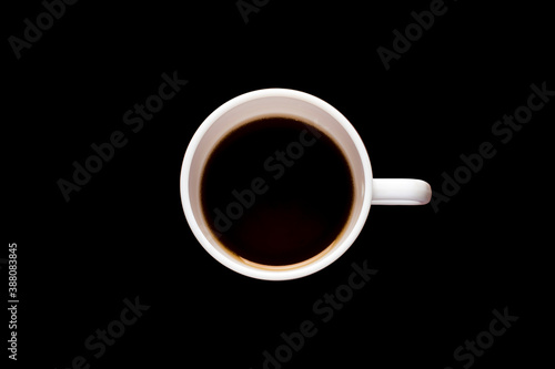 White cup of coffee on a black background.