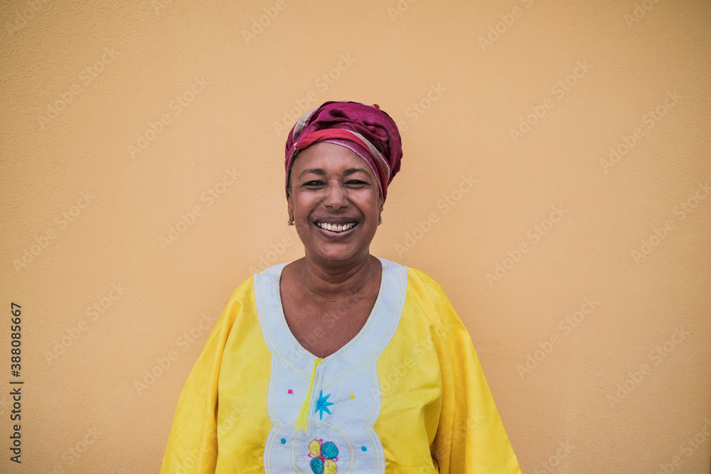 Portrait of happy african senior woman wearing traditional dress Portrait of happy african senior woman wearing traditional dress