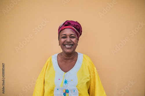 Portrait of happy african senior woman wearing traditional dress