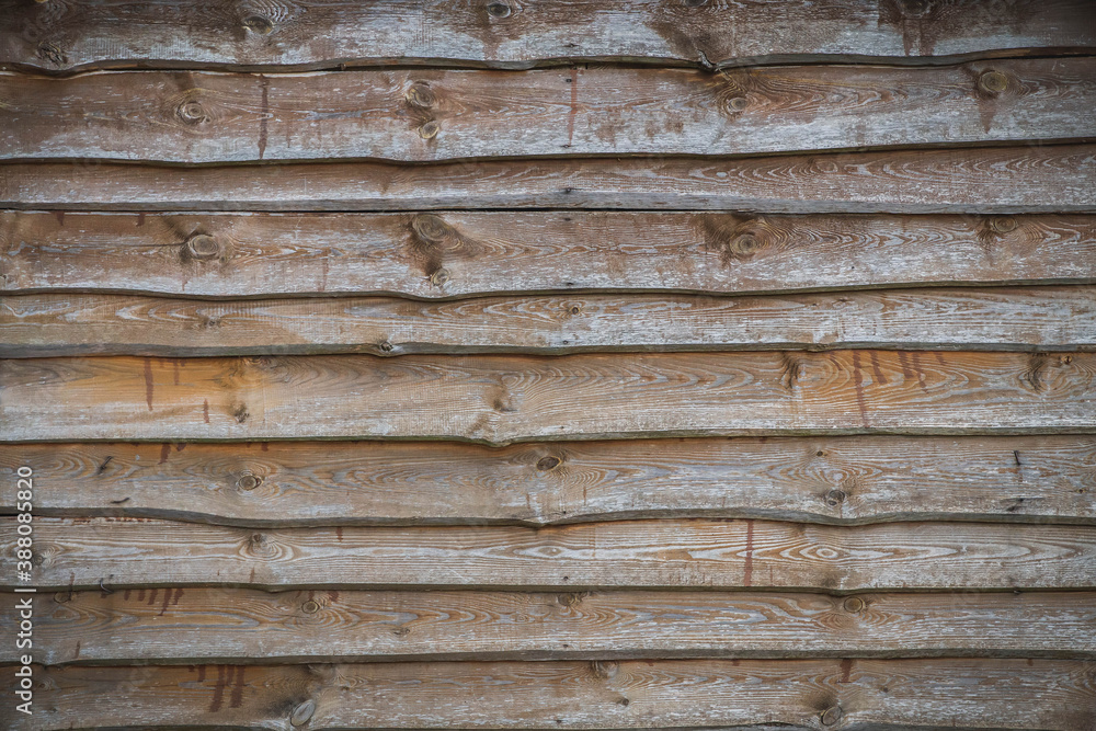 A wall of old planks stacked one on top of the other in a cascade A wall of old planks stacked one on top of the other in a cascade