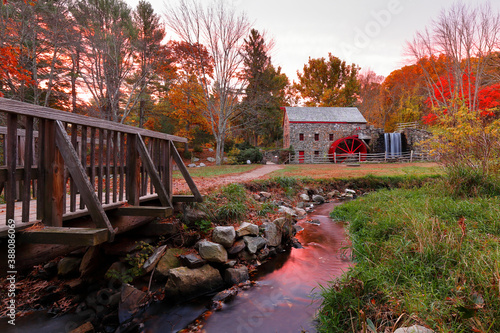 Canvas Print The Wayside Inn Grist Mill with water wheel and cascade water fall in Autumn at