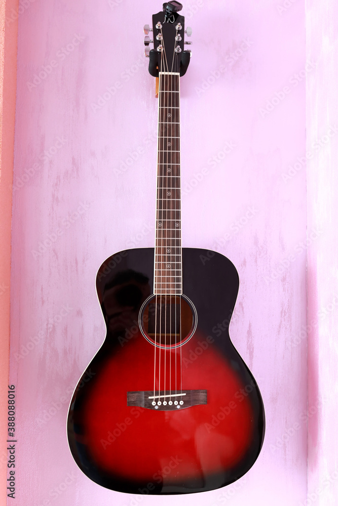 Obraz premium Guitar hanging on wall