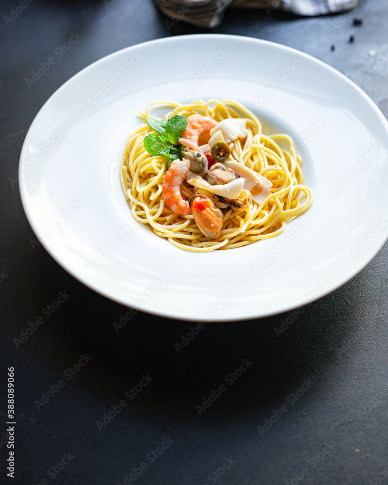 spaghetti seafood pasta shrimp, mussels, squid and more second course top view copy space for text food background rustic