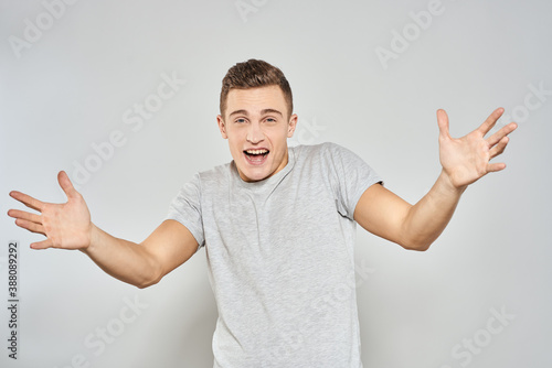 handsome man in light t-shirt cropped view emotion studio isolated background