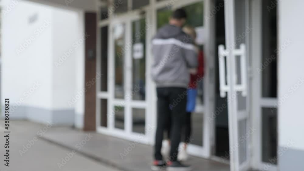 Blurry View of Medical worker remote checks temperature of people at entrance door in Public Place. Measurement Body Temperatures before Entering Public Place, Building. Prevent Covid-19, Coronavirus Blurry View of Medical worker remote checks temperature of people at entrance door in Public Place. Measurement Body Temperatures before Entering Public Place, Building. Prevent Covid-19, Coronavirus