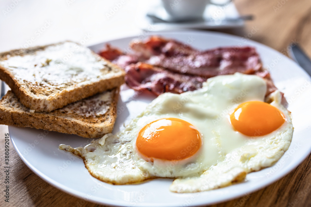 Tasty breakfast with two eggs, bacon, toasts and coffee Tasty breakfast with two eggs, bacon, toasts and coffee