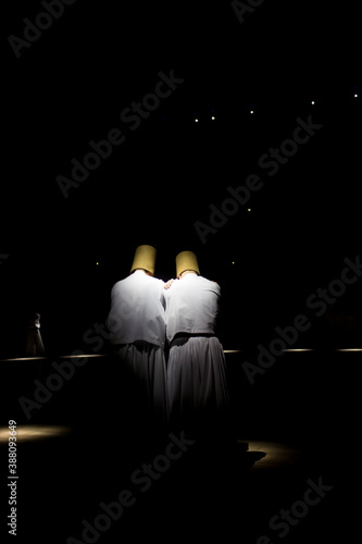 Dervishes perform on the stage for Mevlana photo