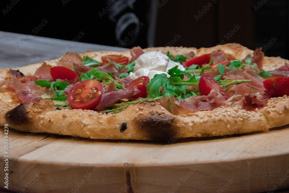 Tasty vegetarian pizza with cherry tomatoes, mozzarella cheese and fresh oregano