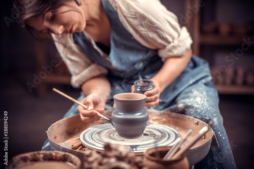Stylish pottery molding a vase of clay on a potter's wheel. Handmade. photo