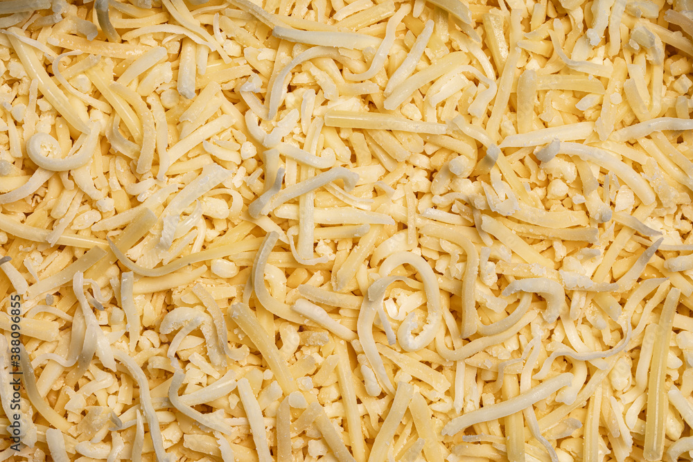 Full frame top view of yellow grated cheese Full frame top view of yellow grated cheese