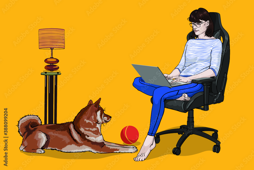 A white woman sits at home on a black armchair and works on a laptop. A dog sits at her feet.
