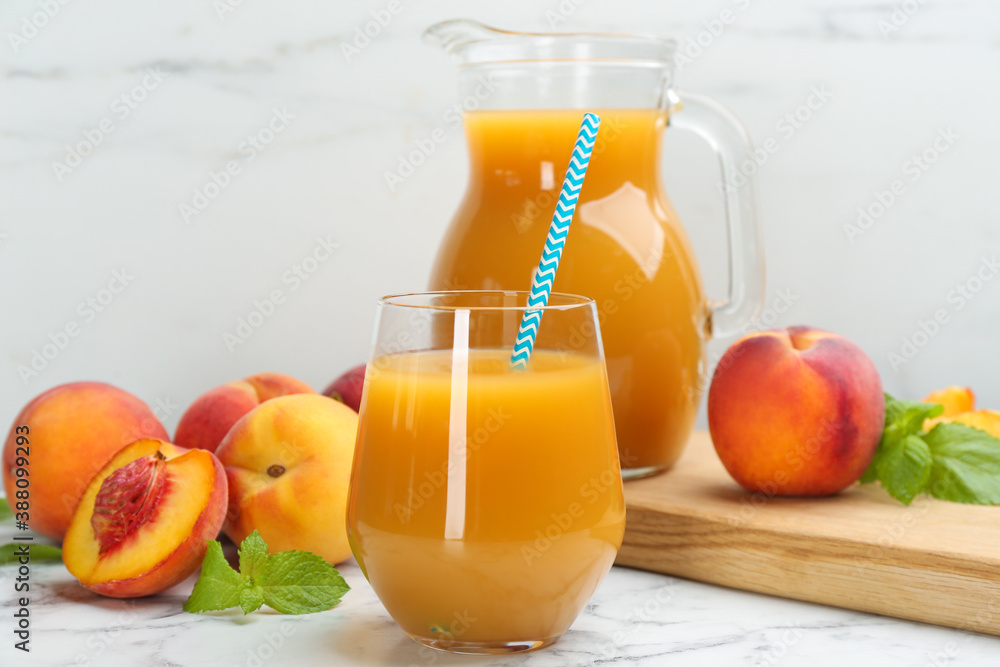 Natural peach juice and fresh fruits on white marble table Natural peach juice and fresh fruits on white marble table