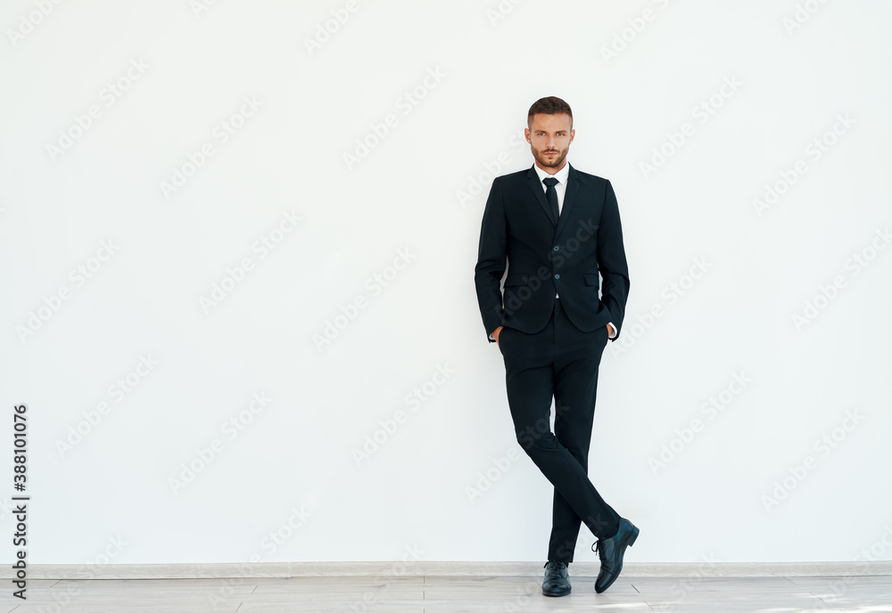 Full length portrait of confident businessman in elegant suite posing on white background Full length portrait of confident businessman in elegant suite posing on white background