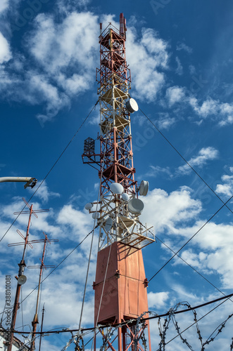 Radio communcations tower against blue sky with clouds photo