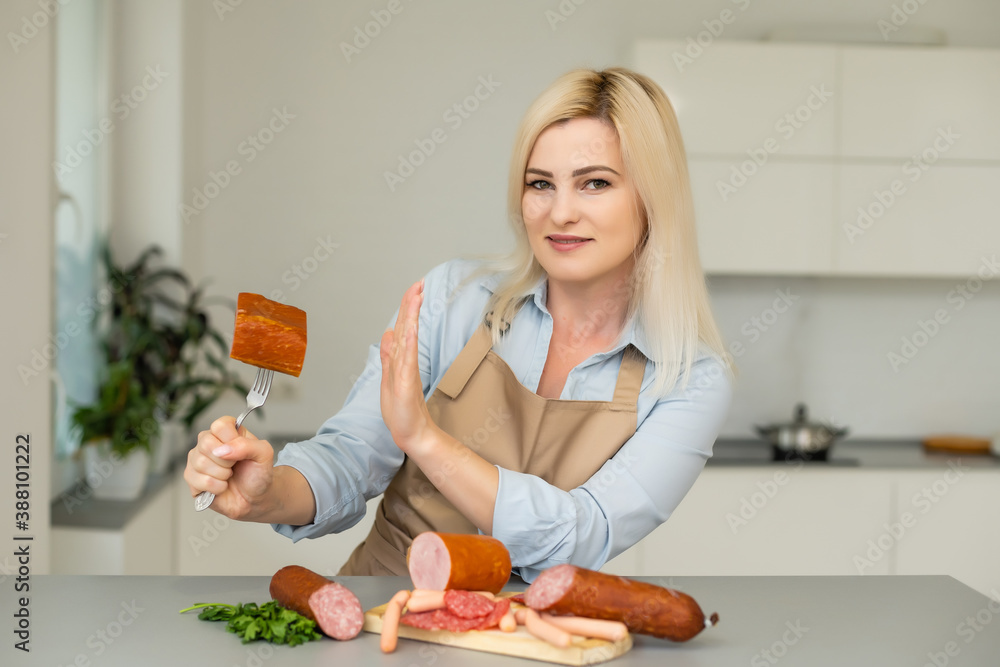 woman refuses sausage on a fork woman refuses sausage on a fork