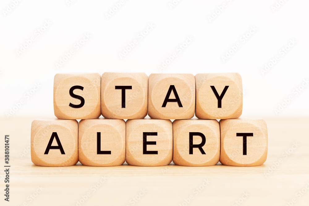 Stay alert concept. Wooden blocks with text on table Stay alert concept. Wooden blocks with text on table