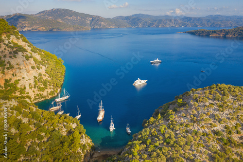 aerial view to hidden lagoon in giant bay in the morning with sailing boats