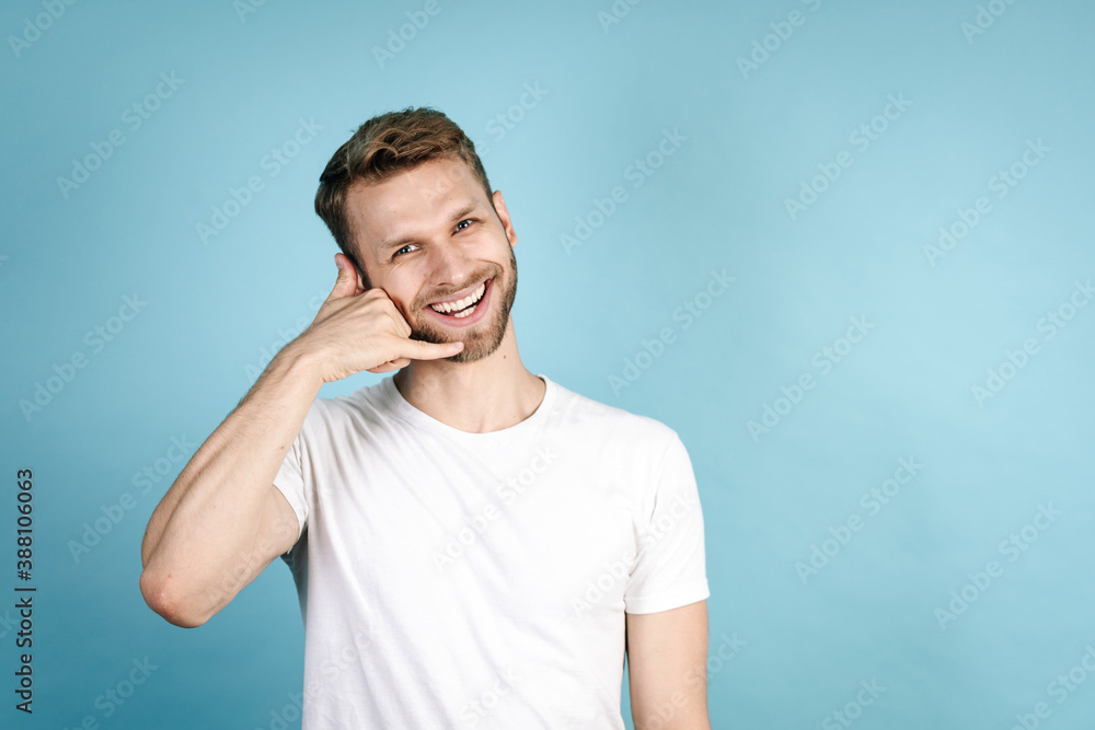 Young adult man making call gesture with hand Young adult man making call gesture with hand