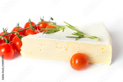 Brie cheese with cherry tomatoes and rosemary isolated