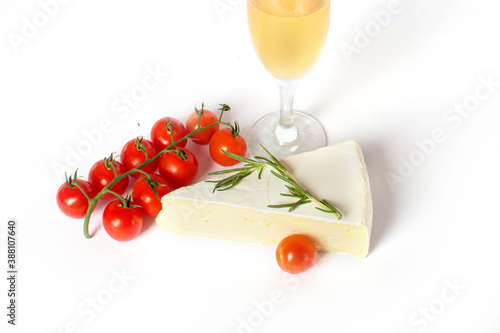 Brie cheese with cherry tomatoes, white wine and rosemary isolated