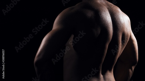 Fit and sporty bodybuilder over black background. Sportsman in studio. Sport and fitness concepts.