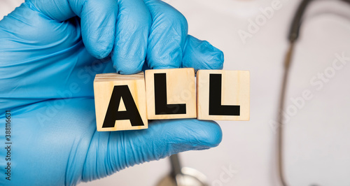 Bilde på lerret ALL Acute lymphoblastic leukemia - word from wooden blocks with letters holding by a doctor's hands in medical protective gloves